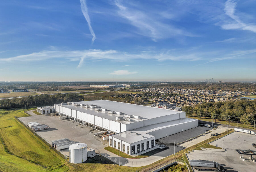 Aerial View of Industrial Warehouse - Aerial shot of an industrial facility with surrounding infrastructure.