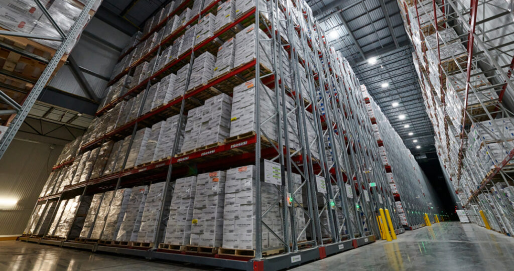 Cold storage facility room with 6 rows of pallets neatly stacked and organized